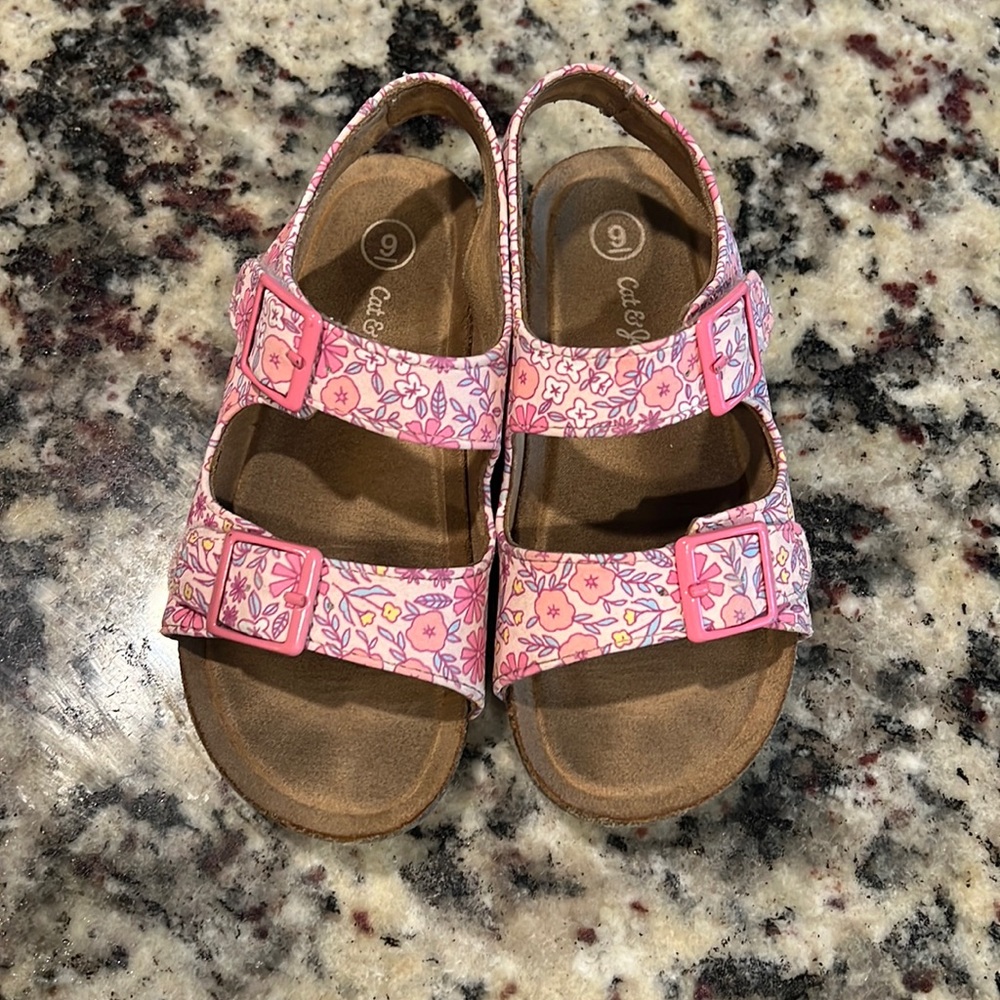 Pink floral sandals with velcro strap.